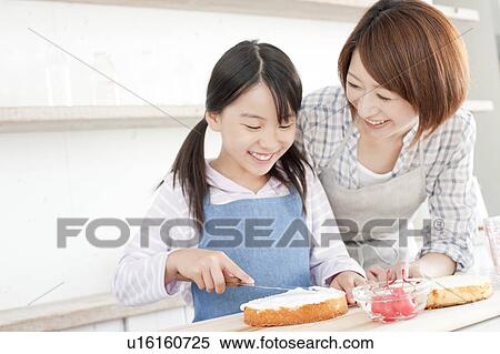 Mother and daughter in kitchen decorating cake, Hyogo Prefecture, Honshu, Japan View Large Photo Image Stock Photography - Mother and daughter in kitchen decorating cake, Hyogo Prefecture, Honshu, Japan. Fotosearch
