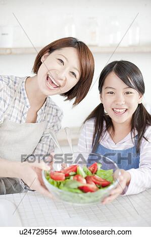 Picture - Mother and daughter making salad, Hyogo Prefecture, Honshu, Japan. Fotosearch