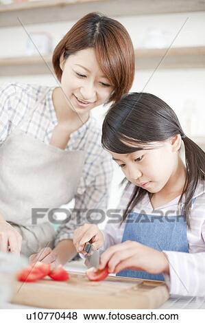 Mother and daughter making salad, Hyogo Prefecture, Honshu, Japan View Large Photo Image Stock Photo - Mother and daughter making salad, Hyogo Prefecture, Honshu, Japan. Fotosearch