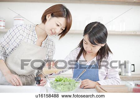 Mother and daughter making salad, Hyogo Prefecture, Honshu, Japan View Large Photo Image Stock Photo - Mother and daughter making salad, Hyogo Prefecture, Honshu, Japan. Fotosearch