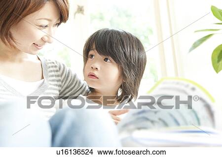 Picture - Mother and son reading a book. Fotosearch