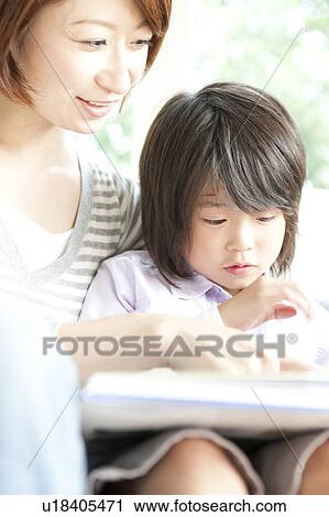 Stock Image - Mother and son reading a book. Fotosearch