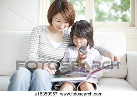 Stock Photo - Mother and son reading a book. Fotosearch