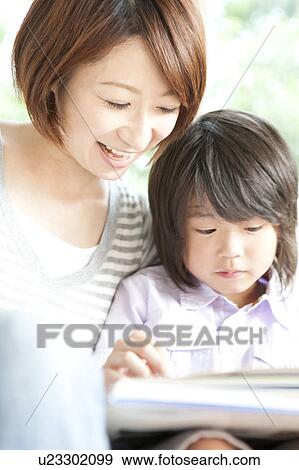 Mother and son reading a book View Large Photo Image Stock Photo - Mother and son reading a book. Fotosearch