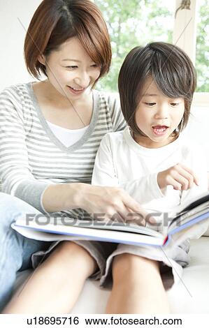 Stock Photograph - Mother and son reading a book. Fotosearch