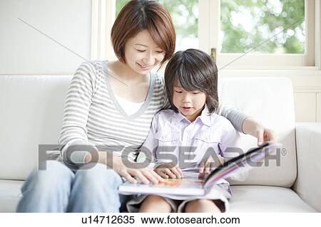Mother and son reading a book View Large Photo Image Stock Photography - Mother and son reading a book. Fotosearch