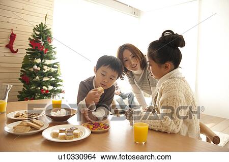 Picture - Mother, Daughter and Son at Christmas. Fotosearch