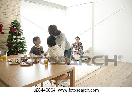 Mother, Daughter and Son at Dining Table at Christmas View Large Photo Image Picture - Mother, Daughter and Son at Dining Table at Christmas. Fotosearch