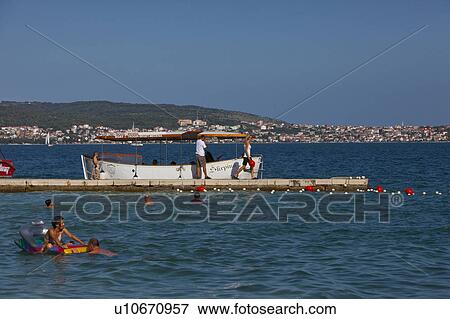 Stock Photo - People Enjoying Themselves at Seaside. Fotosearch