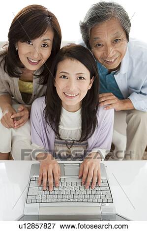 Portrait of family using laptop View Large Photo Image Stock Photo - Portrait of family using laptop. Fotosearch