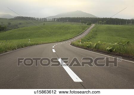 Stock Image - Road at dusk, Hokkaido Prefecture, Japan. Fotosearch