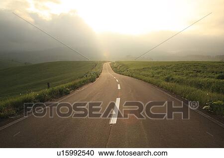 Stock Image - Road at dusk, Hokkaido Prefecture, Japan. Fotosearch
