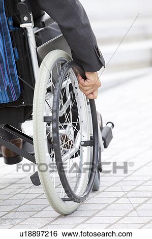 Stock Photograph - Senior man on wheelchair, close-up. Fotosearch