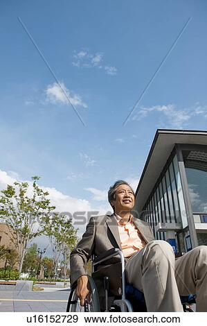 Stock Photo - Senior man on wheelchair. Fotosearch