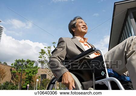 Stock Photograph - Senior man on wheelchair. Fotosearch
