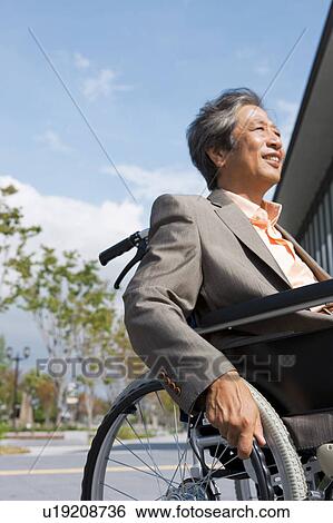 Stock Photograph - Senior man on wheelchair. Fotosearch