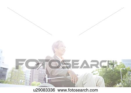Stock Photograph - Senior man on wheelchair. Fotosearch