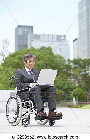 Senior man on wheelchair using laptop View Large Photo Image Stock Image - Senior man on wheelchair using laptop. Fotosearch