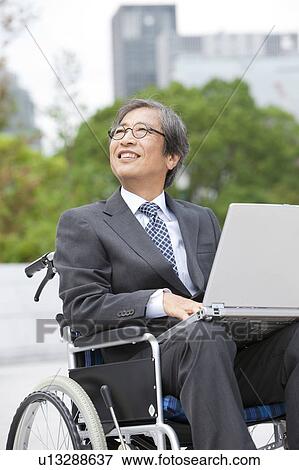 Senior man on wheelchair using laptop View Large Photo Image Stock Photo - Senior man on wheelchair using laptop. Fotosearch