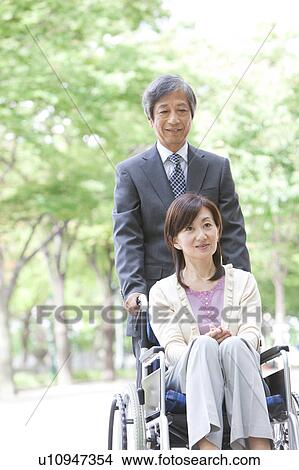 Senior man with wife in wheelchair View Large Photo Image Picture - Senior man with wife in wheelchair. Fotosearch