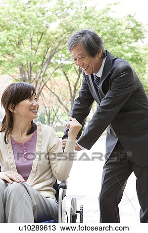 Senior man with wife in wheelchair View Large Photo Image Stock Image - Senior man with wife in wheelchair. Fotosearch