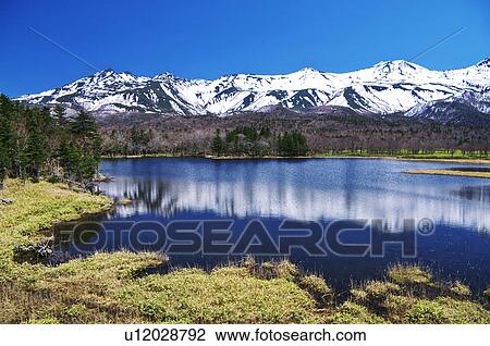 Stock Image - Shiretoko mountain range and lake, Hokkaido Prefecture, Japan. Fotosearch