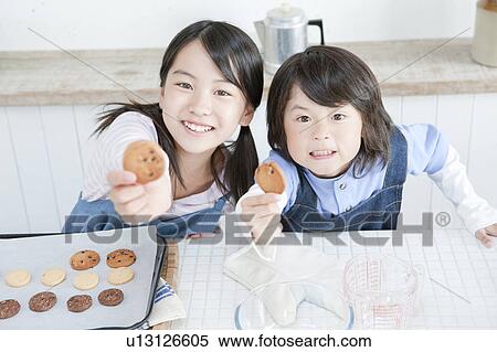 Sister and brother holding cookies, Hyogo Prefecture, Honshu, Japan View Large Photo Image Stock Photography - Sister and brother holding cookies, Hyogo Prefecture, Honshu, Japan. Fotosearch