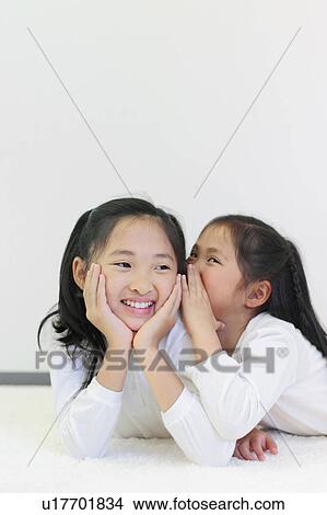 Picture - Sisters Whispering. Fotosearch