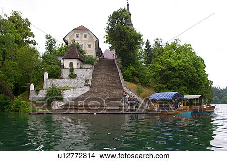 Steps to Bled Island and Pilgrimage Church of the Assumption of Mary at Lake Bled View Large Photo Image Picture - Steps to Bled Island and Pilgrimage Church of the Assumption of Mary at Lake Bled. Fotosearch