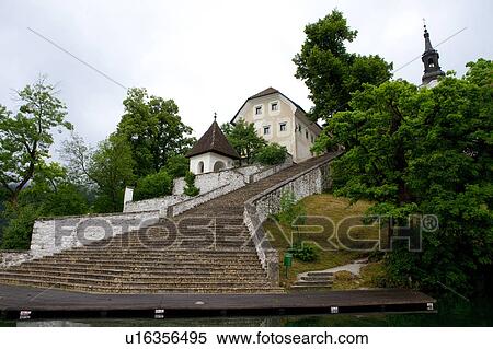 Stock Photography - Steps to Bled Island and Pilgrimage Church of the Assumption of Mary at Lake Bled. Fotosearch