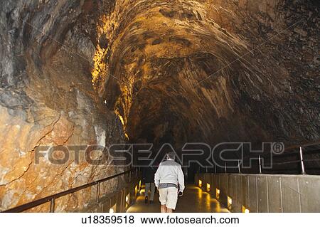 Stock Photo - Tourist Walking in Postojna Cave. Fotosearch