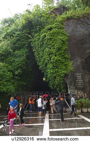 Stock Photograph - Tourists at Postogna Cave. Fotosearch