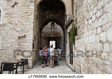 Stock Image - Tourists Walking at Diocletian Royal Palace. Fotosearch