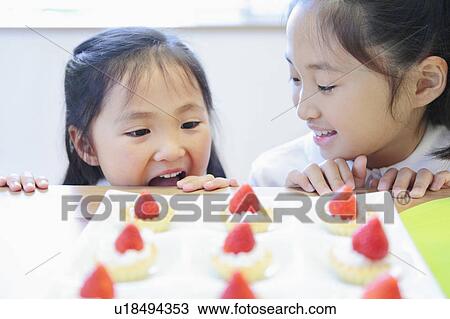 Two Girls Looking at Cakes View Large Photo Image Stock Image - Two Girls Looking at Cakes. Fotosearch