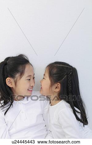 Two Sisters Looking At Each Other View Large Photo Image Stock Image - Two Sisters Looking At Each Other. Fotosearch