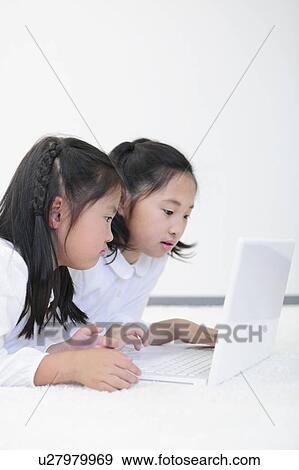 Two Sisters Using Laptop View Large Photo Image Stock Photo - Two Sisters Using Laptop. Fotosearch
