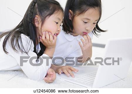 Two Sisters Using Laptop View Large Photo Image Stock Photograph - Two Sisters Using Laptop. Fotosearch
