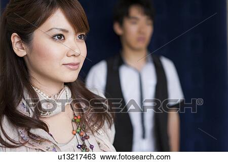 Stock Image - Young couple standing. Fotosearch