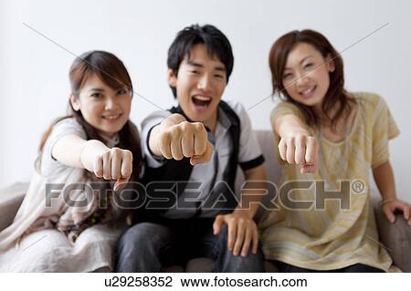 Young friends making a fist View Large Photo Image Stock Image - Young friends making a fist. Fotosearch
