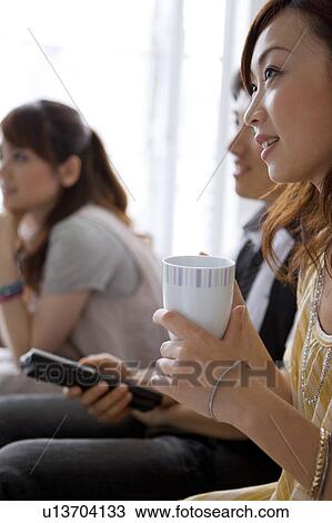 Young friends watching television View Large Photo Image Stock Image - Young friends watching television. Fotosearch