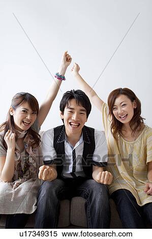 Young friends watching television View Large Photo Image Stock Photography - Young friends watching television. Fotosearch