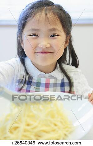 Stock Photograph - Young Girl Having Spaghetti. Fotosearch
