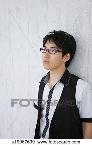 Young man leaning on wall View Large Photo Image Stock Photo - Young man leaning on wall. Fotosearch