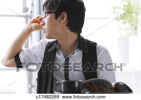 Young man looking out the window View Large Photo Image Stock Photo - Young man looking out the window. Fotosearch