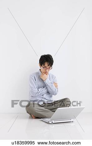 Young man wearing red glasses with laptop View Large Photo Image Stock Photography - Young man wearing red glasses with laptop. Fotosearch