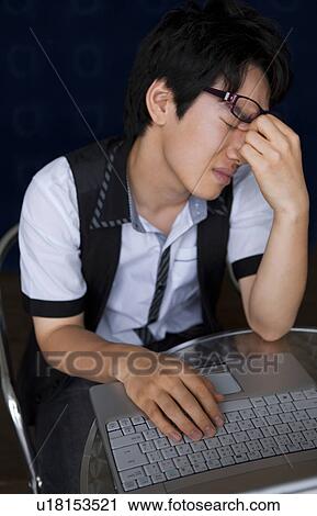 Stock Image - Young man with tired eyes. Fotosearch