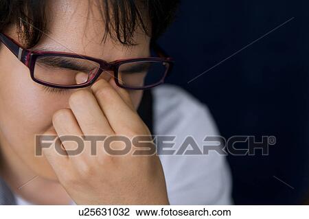 Young man with tired eyes View Large Photo Image Stock Image - Young man with tired eyes. Fotosearch