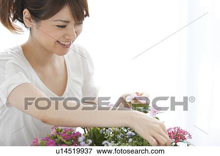 Stock Photo - Young woman gardening. Fotosearch