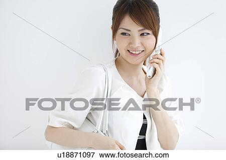 Young woman on a cell phone View Large Photo Image Stock Photo - Young woman on a cell phone. Fotosearch
