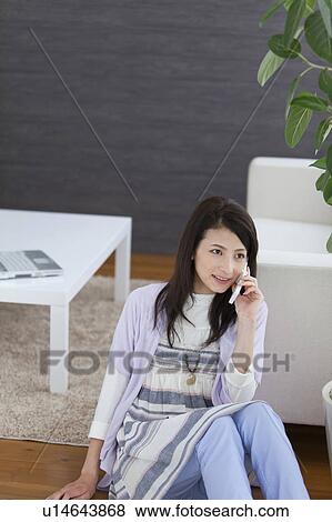 Young woman on cell phone View Large Photo Image Stock Photo - Young woman on cell phone. Fotosearch